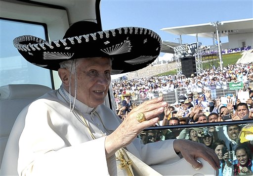 Pope Benedict XVI waves from the popemobile wearing a Mexican sombrero as he arrives to give a Mass in Bicentennial Park near Silao, Mexico, in this March 25, 2012, photo.