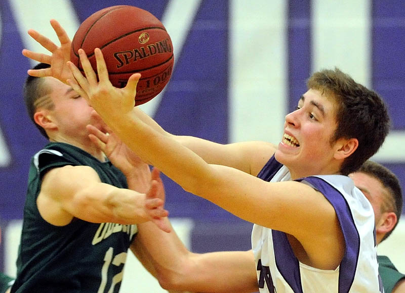 Old Town High School's Cam Archer, 12, left, and Waterville Senior High School's Owen Brown, 32, battle for the loose ball in the second half in the Class B preliminary play-off game in Waterville Wednesday night, Waterville defeated Old Town 75-33.