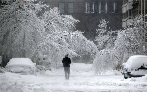 A pedestrian braves the storm in Kansas City, Mo., on Tuesday.