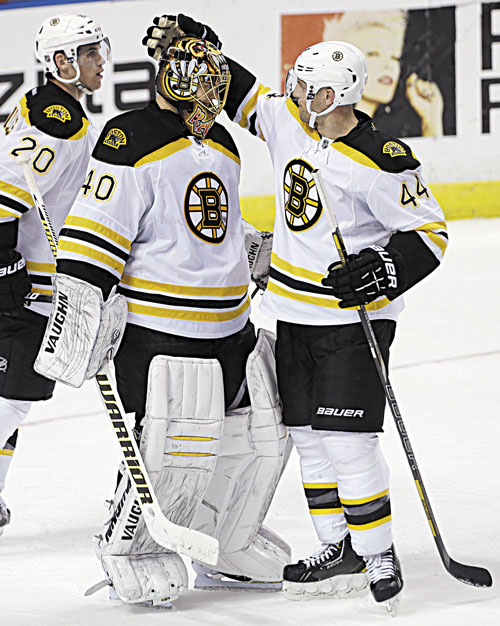 NICE JOB: Boston Bruins goalie Tuukka Rask (40) and Dennis Seidenbery (44) celebrate after their 4-1 win over the Florida Panthers on Sunday in Sunrise, Fla. Rask made 34 saves to earn the victory.