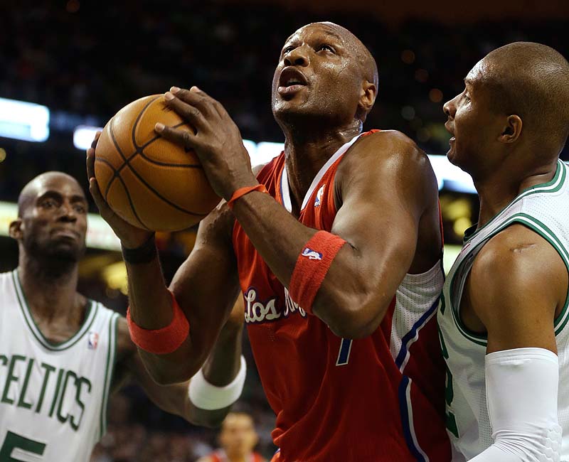 Lamar Odom of the Clippers drives toward the basket while under pressure from Boston's Kevin Garnett, left, and Leandro Barbosa in Sunday's game at TD Garden. The Celtics won, 106-104.