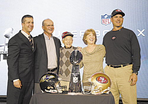 FAMILY TIME: San Francisco 49ers head coach Jim Harbaugh, right, and Baltimore Ravens head coach John Harbaugh, left, pose with their parents, Jack and Jackie, and grandfather Joe Cipiti during a news conference Friday in New Orleans.