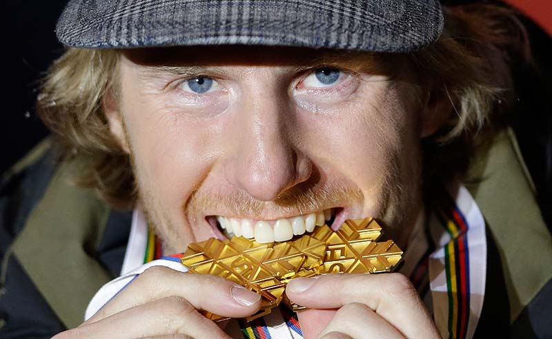 Ted Ligety, of the United States, takes a bite out of his gold medal in the giant slalom. Ligety won three golds at the Alpine skiing world championships in Schladming, Austria.