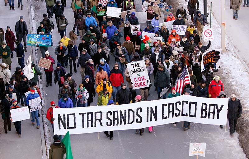 People march down Commercial Street in Portland on Saturday, Jan. 26, 2013 to protest what they say is a proposal to send tar sands oil from Canada through a pipeline to Portland harbor.