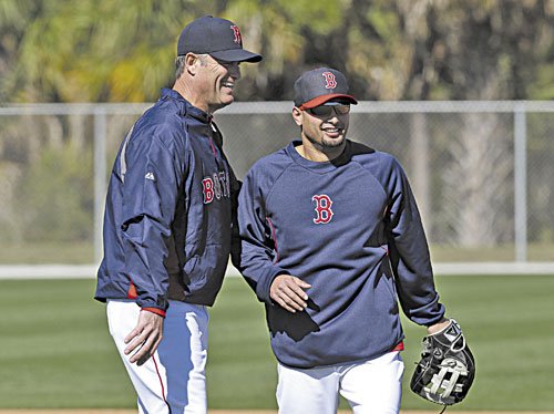 GOOD TO HAVE YOU HERE: Boston Red Sox outfielder Shane Victorino, right, laughs with manager John Farrell during a spring training workout Sunday in Fort Myers, Fla.