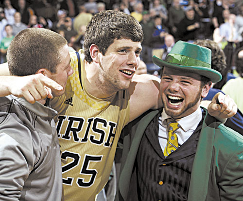 MAKING GOOD: Notre Dame forward Tom Knight celebrates with Leprechaun Bryce Burton following a104-101 five overtime win against Louisville on Saturday in South Bend, Ind. Knight is a Dirigo High School graduate.
