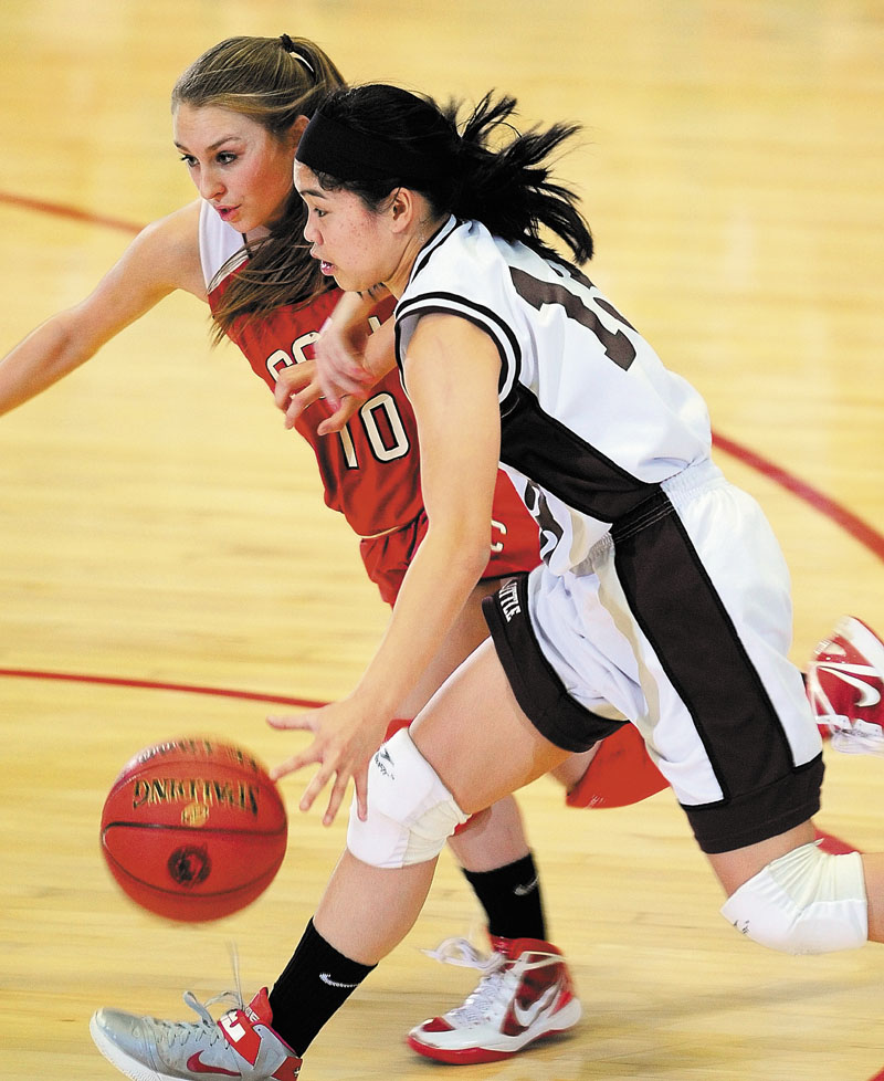 Cony's Olivia Deeves, left, tries to stop drive by Edward Little's Katherine Sawyer during an Eastern Class A tournament game on Friday February 15, 2013 at the Augusta Civic Center.