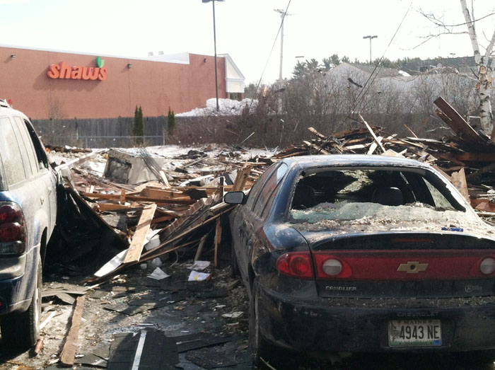 Debris and damaged vehicles from this morning's explosion at 29-31 Bluff Road, which is adjacent to Shaw's supermarket.