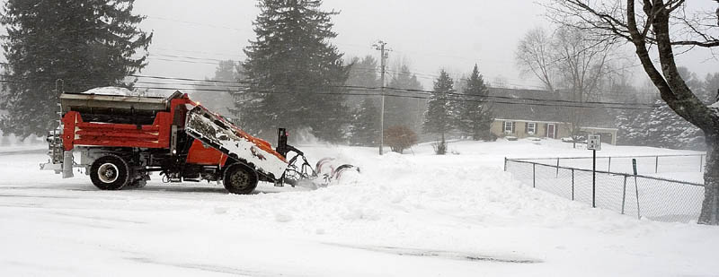 Augusta Public Works plow truck driver Stan Moore makes several passes as he clears the intersection of Leighton and Mount Vernon Roads around 10:45 a.m.. on Saturday, cleaning up from the blizzard in Augusta.