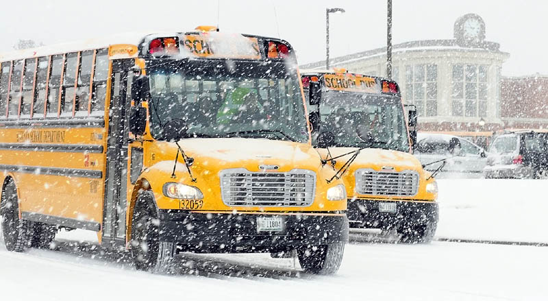 Buses leave Cony High School at 10:45 a.m. on Friday as students were released early for the winter storm in Augusta.