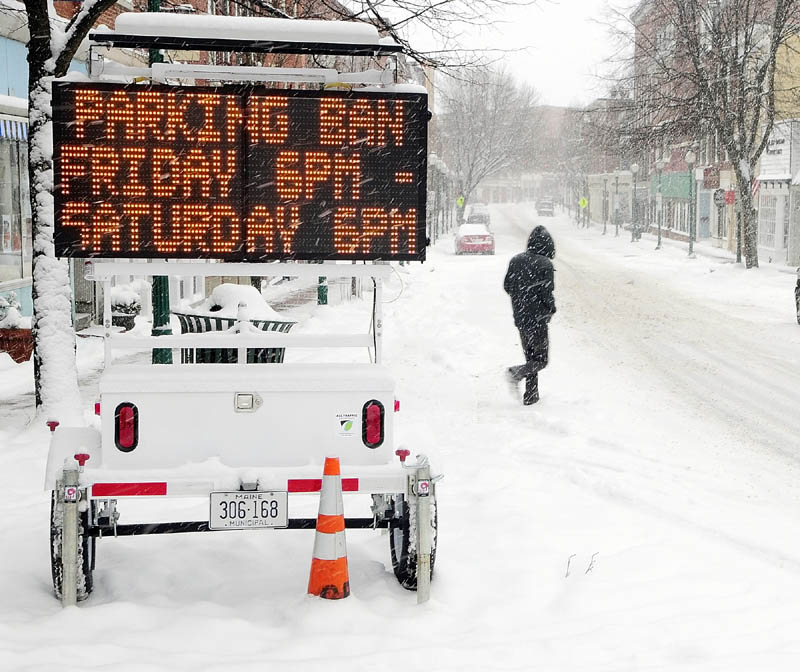 A flashing sign on Water Street announces the parking ban on all streets in the city of Gardiner starting at 6 pm. on Friday.