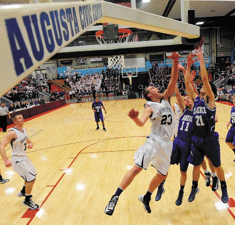 Nick Noiles battle for rebound during the Eastern Class A championship game Friday at the Augusta Civic Center. Hampden, the No. 1 seed, made a desperation 3-pointer at the buzzer to beat the Bulldogs, 40-39.