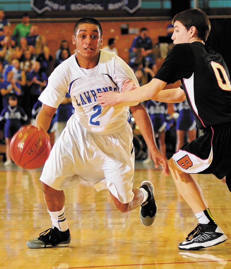 Lawrence's Xavier Lewis tries to dribble past Brunswick's Blake Gordon during an Eastern Class A tournament game on Saturday February 16, 2013 at the Augusta Civic Center.