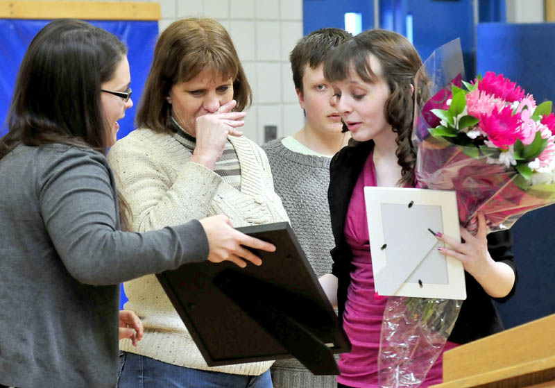 Madison Memorial High School student Lanie Howes, right, receives the Brendan Batson award for fundraising from Make-A-Wish Maine Events Manager Rebecca Leaming, left, on Thursday. Reacting is Batson's mother, Yvonne, and brother, Nathanael.