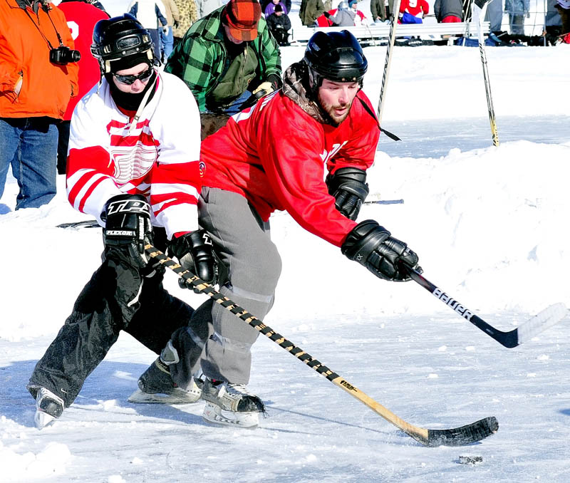 CLASSIC: Jeff Browne, right, of the Winslow-based Cioppa team, battles for possession of the puck with a Portland area player during the Maine Pond Hockey Classic on Sunday on China Lake. Cioppa finished runner-up to Hart Construction.