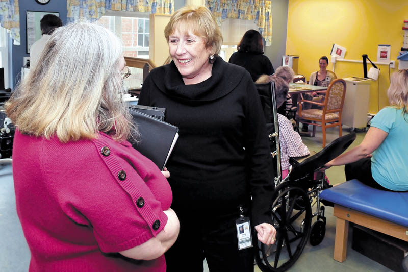 Sara Sylvester, right, administrator at the Oak Grove Center in Waterville, speaks with employee Betty Bayley in a rehabilitation unit on Thursday. Sylvester said that the facility is concerned about funding shortfalls that could impact staffing.