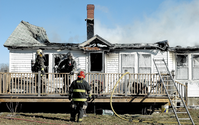 Smoke lingers over the remains of Bonnie and Darrell Gilbert's home after it was destroyed by fire Thursday in St. Albans.