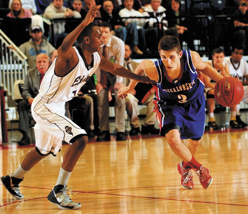 Messalonskee's Jordan Holmes, right, dribbles past Edward Little's Mahad Mohamed during an Eastern Class A tournament game on Saturday February 16, 2013 at the Augusta Civic Center.