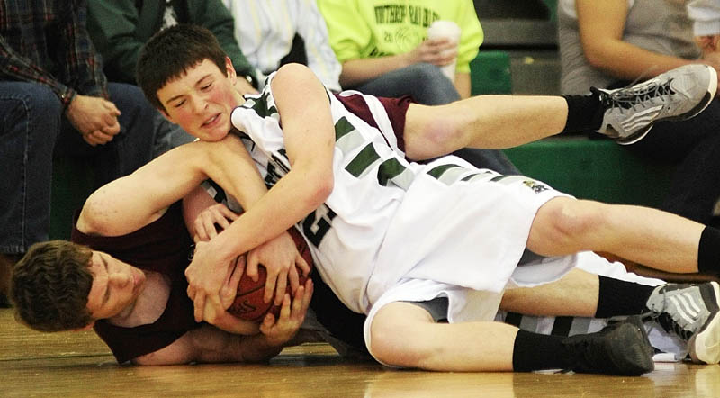 FIGHT FOR THE BALL, TRIP TO AUGUSTA: Monmouth Academy’s Drew McFarren, left, and Winthrop’s Matt Sekerak wrestle for a loose ball during a Western C prelim game Wednesday at Winthrop High School.