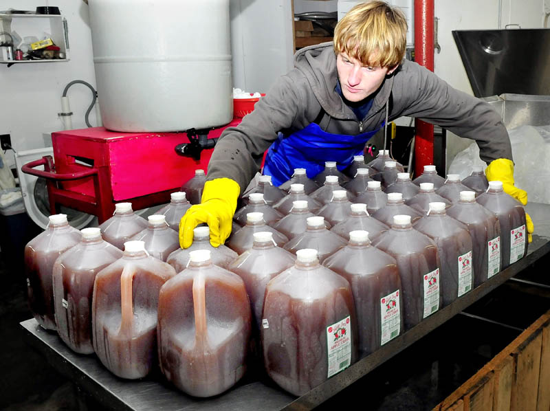 Bartley Hinson bottles cider, which was recently pressed at The Apple Farm in Fairfield on Wednesday. The apples harvested last fall have been in cold storage and produce a sweeter tasting cider.