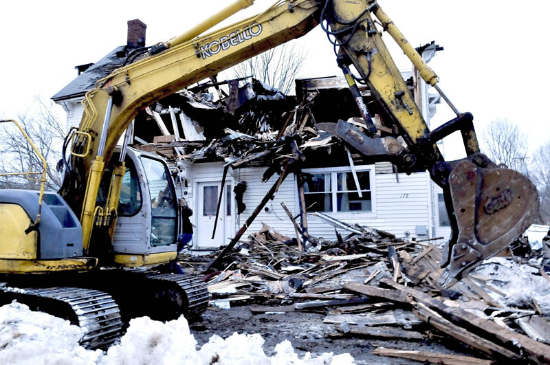 Nick Ferreira uses an excavator to clear debris in front of 178 Main Street in Unity on Tuesday. The work was done so former tenants could enter the burned building to retrieve belongings. Owner Ralph Nason Sr. said he has not decided what to do with the lot. "Right now I'm waiting on the insurance company," Nason said.
