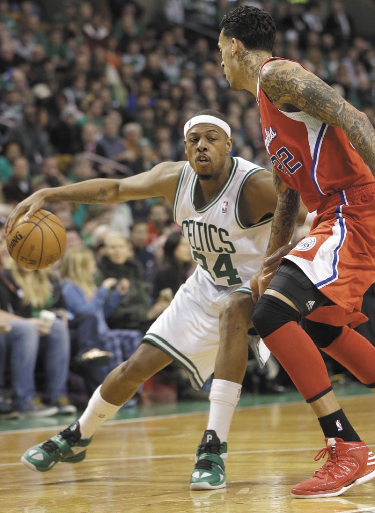 MAKE A MOVE: Boston’s Paul Pierce, left, looks for an opening around Los Angeles’ forward Matt Barnes in the fourth quarter of the Celtics’ 106-104 win Sunday at the TD Garden in Boston.