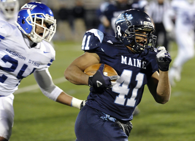 Maine running back Nigel Jones breaks away from Georgia State’s Kail Singleton on the way to a 9-yard touchdown run in a game last year. The University of Maine will will be on the road for four of its first five football games this fall, according to the schedule released by the college Thursday afternoon.