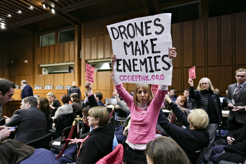 Protesters opposed to drone strikes by the CIA disrupt the start of the hearing.