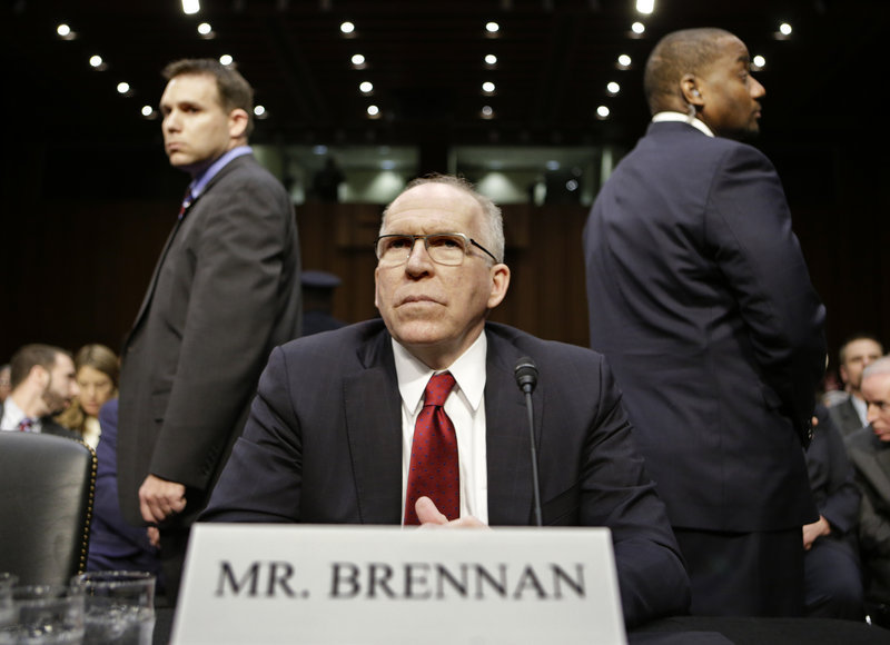 CIA director nominee John Brennan, flanked by security, prepares to testify at his confirmation hearing before the Senate Intelligence Committee on Thursday.