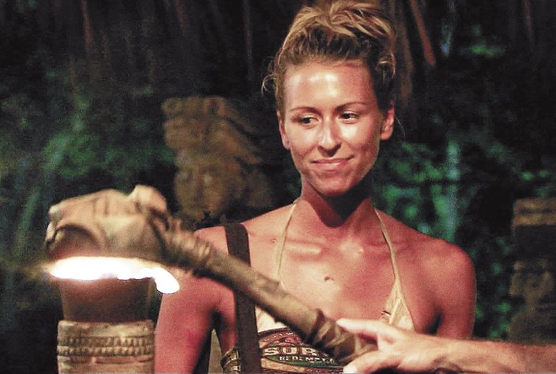 Ashley Underwood, who grew up in Benton, watches as her torch is extinguished, signaling her removal from the game show “Survivor,” in 2011.