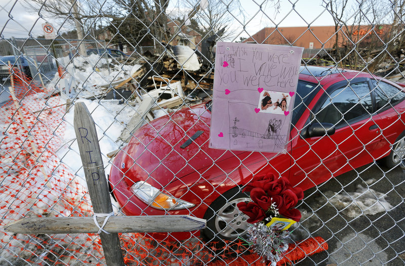 A memorial to Dale Fussell covers a fence at 29 Bluff Road in Bath. Officials believe a loose pipe coupling at the building allowed propane gas to escape, leading to an explosion.
