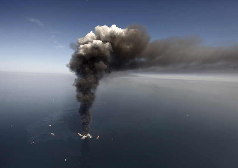 Oil can be seen spreading in the Gulf of Mexico more than 50 miles southeast of Louisiana, as a large plume of smoke rises from fires on BP’s Deepwater Horizon offshore oil rig on April 21, 2010.