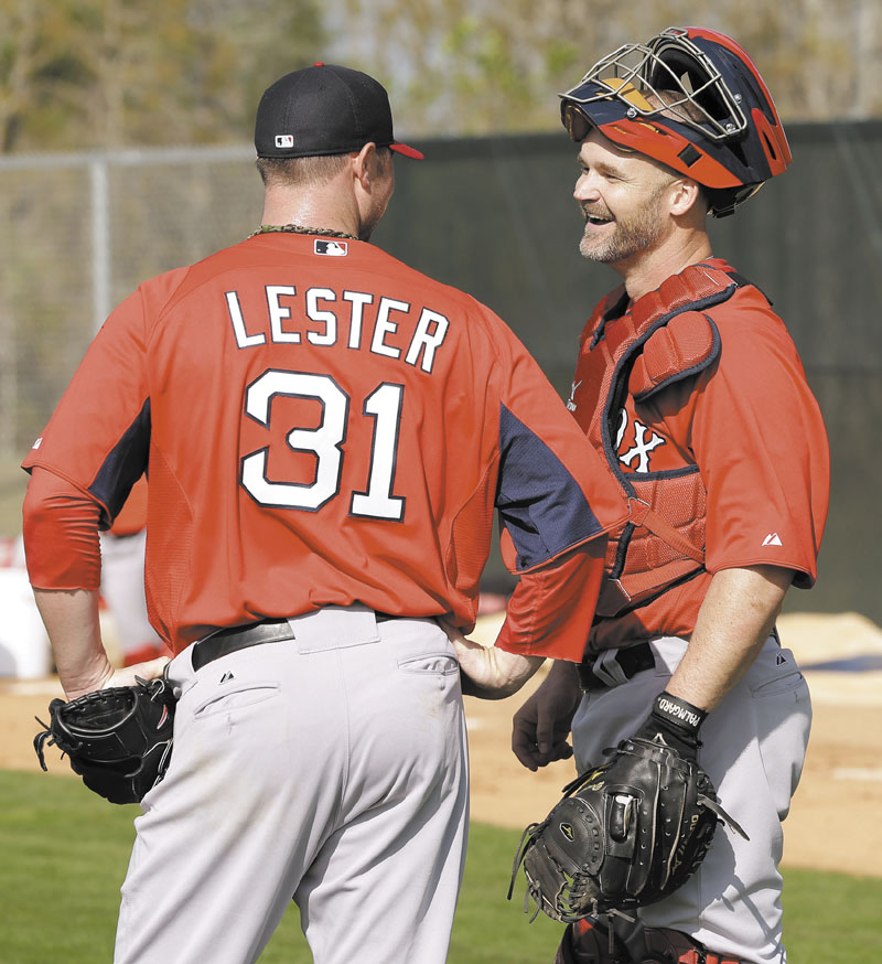 HAPPY TO BE BACK: Boston Red Sox catcher David Ross, right, talks to pitcher Jon Lester on Wednesday in Fort Myers, Fla. Lester is trying to bounce back from a tough 2012 when he finished 8-14 with a career-high 4.82 ERA.