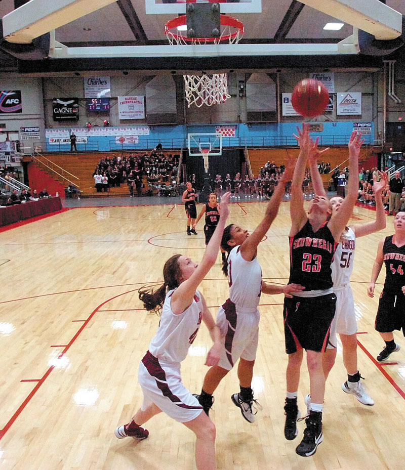 Skowhegan Area High School senior forward Adriana Martineau, 23, puts a rebound back up and in for two points during an Eastern Class A tournament game against Bangor High School on Friday February 15, 2013 at the Augusta Civic Center.
