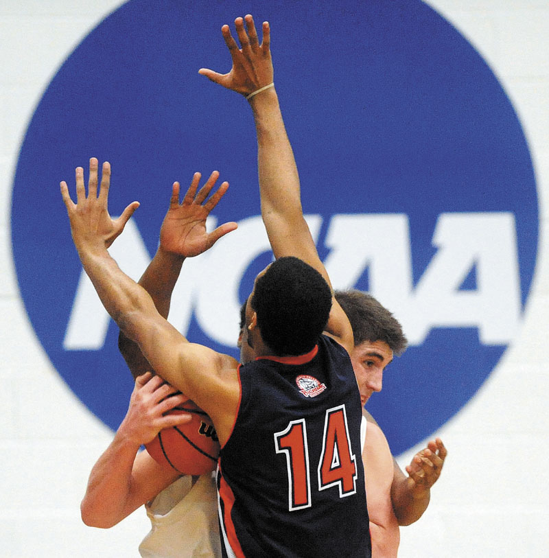 University of Maine at Farmington’s Ben Johnson is double-teamed by New England College defenders Joel DeMadet, 14, and Jaskin Melendez in the first half Tuesday of a North Atlantic Conference tournament game in Farmington. The Beavers won 85-66. For the local college roundups, see C4.