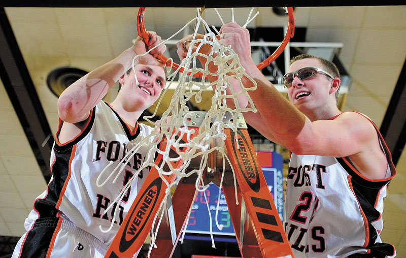 Forest Hills players Ryan Petrin, left, and Derick Ouellette cut down the net after winning the Western Class D boys' championship game Saturday at the Augusta Civic Center. The Tigers beat Valley, 40-33.