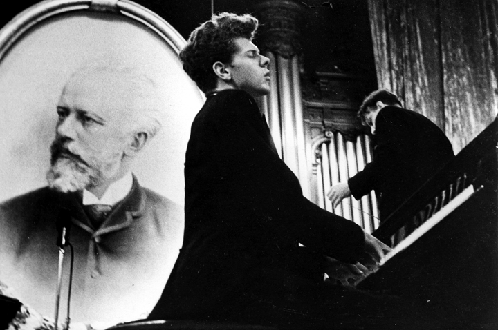 Van Cliburn performs in the Great Hall of the Moscow Conservatory in front of a picture of composer Pytor Ilyich Tchaikovsky in April 1958 during the first International Tchaikovsky Competition, which he won.