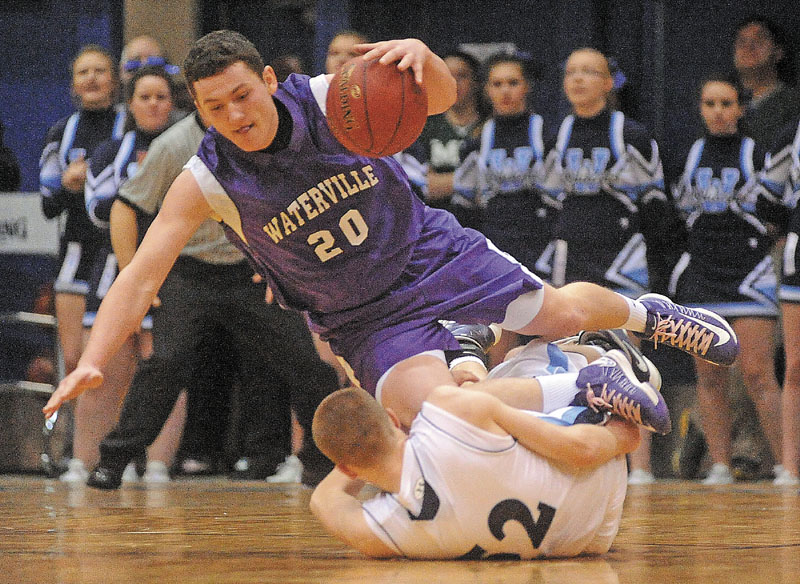 Waterville's Josh Gormley is tripped by Presque Isle's Bradley Shields in the second half of their Eastern Class B quarterfinal Saturday. Presque Isle won, 47-45.