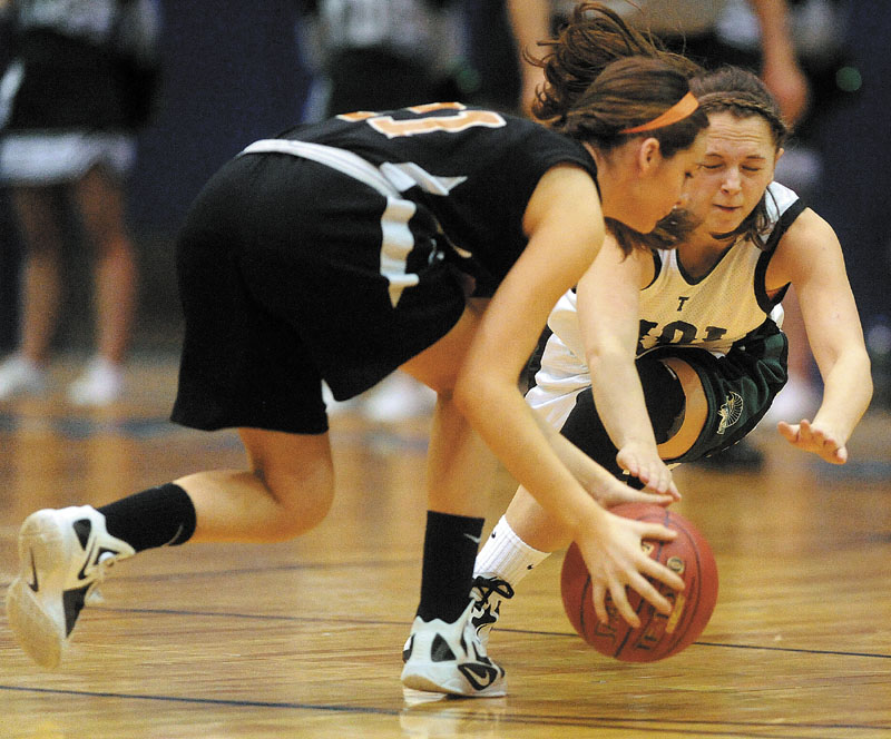 Winslow's Delaney Wood, left, and Mt. Desert Isle's Molly Carroll go after a loose ball in their Eastern Class B quarterfinal Saturday. MDI won, 38-31.