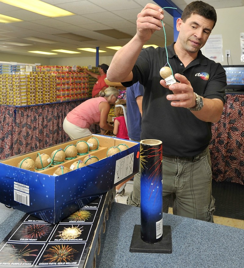 In this June 2012 file photo, store manager Scott Mitchell explains how the newer fireworks are safer than the older models at Atlas Fireworks Company on Route One in Scarborough. Bills repealing and restricting Maine's fireworks laws are currently in front of the Legislature.