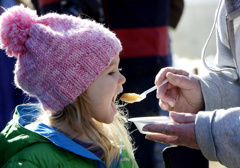 Persephone Karecki 3, of Newfield takes a bite of a pancake soaked in maple syrup while visiting Hilltop Boilers in Newfield on Maine Maple Sunday.