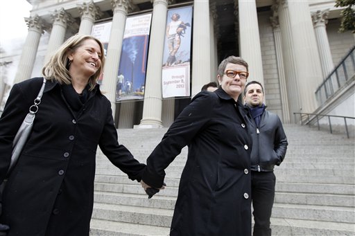 Sandy Stier, left, and Kris Perry of Berkeley, Calif., stand outside the National Archives in Washington on Monday, before going inside to view the U.S. Constitution, a day before their same-sex marriage case is argued before the Supreme Court.
