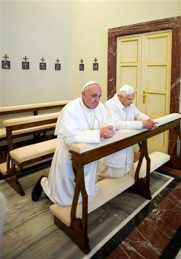 In this photo provided by the Vatican paper L'Osservatore Romano, Pope Francis, left, and Pope emeritus Benedict XVI pray together in Castel Gandolfo Saturday. Pope Francis has traveled to Castel Gandolfo to have lunch with his predecessor Benedict XVI in a historic and potentially problematic melding of the papacies that has never before confronted the Catholic Church.