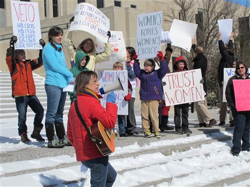 In this March 25 photo, Kris Kitko leads chants of protest at an abortion-rights rally at the state Capitol in Bismarck, N.D.