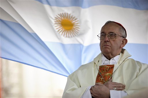In this Aug. 7, 2009 file photo, Argentina's Cardinal Jorge Bergoglio gives a Mass outside the San Cayetano church where an Argentine flag hangs behind in Buenos Aires, Argentina. On Wednesday, March 13, 2013, Bergoglio was elected pope, the first ever from the Americas and the first from outside Europe in more than a millennium. He chose the name Pope Francis. (AP Photo/Natacha Pisarenko)