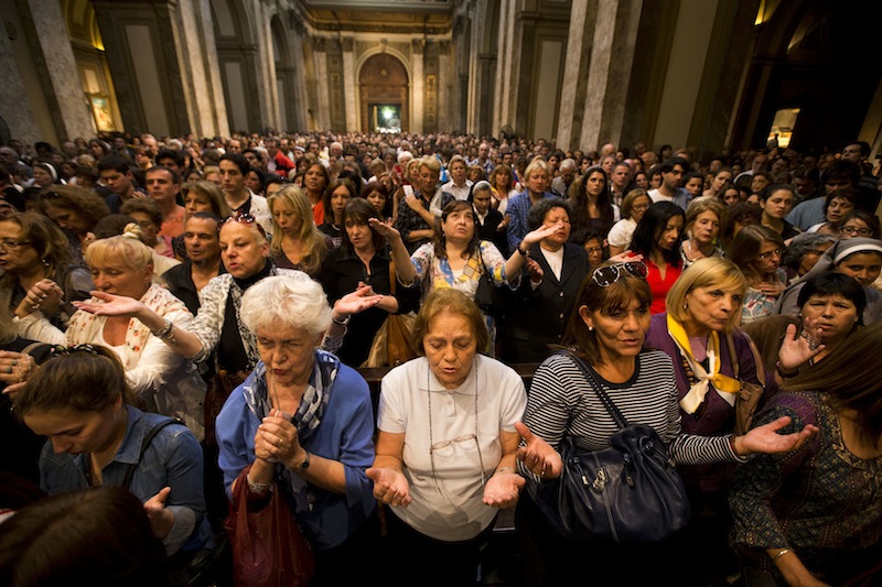 Worshipers pack the Metropolitan Cathedral during the evening Mass in Buenos Aires, Argentina, Wednesday, March 13, 2013. Latin Americans reacted with joy on Wednesday at news that the Argentine Cardinal Jorge Mario Bergoglio, was elected pope. Bergoglio, who chose the name Pope Francis, is the first pope ever from the Americas. (AP Photo/Victor R. Caivano)