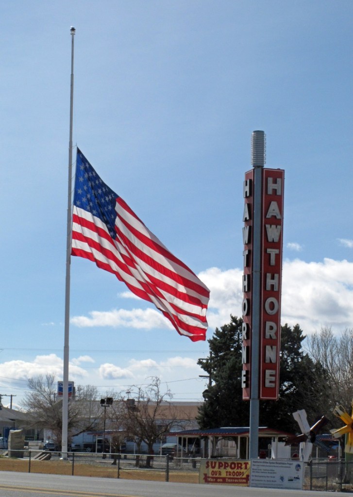 An American flag waves at half staff in the town of Hawthorne near the Hawthorne Army Depot on Tuesday, March 19, 2013, where seven Marines were killed and several others seriously injured in a training accident Monday night, about 150 miles southeast of Reno in Nevada's high desert. (AP Photo/Scott Sonner)