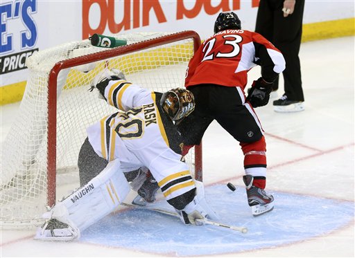 Boston Bruins goaltender Tuukka Rask(40) looks on as Ottawa Senator Kaspars Daugavins attempts an unconventional way of shooting the puck with the tip of his stick during a shoot out and in Ottawa Monday March 11, 2013. Boston beat Ottawa 3-2. (AP Photo/The Canadian Press, Fred Chartrand) action;athlete;athletic;athletics;Canada;Canadian;compete;competition;competitive;cppixottawa Canada;game;hockey;ice hockey;League;National;NHL;play;sports
