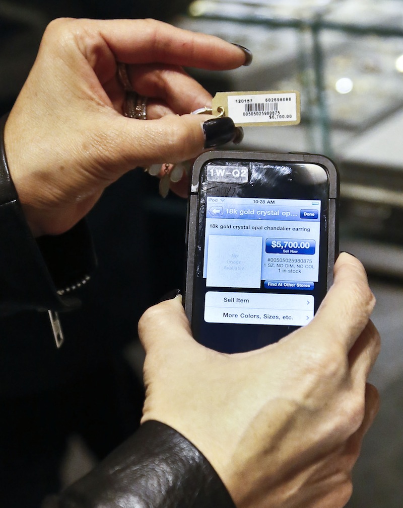 A sales staff member at Barneys New York uses an iPod Touch to help a customer make a purchase. Stores across the country are ditching cash registers and instead having salespeople – and shoppers themselves – check out on smartphones and tablet computers.