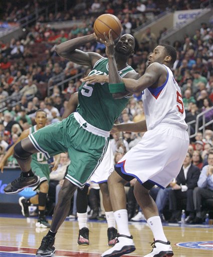 Boston Celtics' Kevin Garnett ,left drives against Philadelphia 76ers' Arnett Moultrie (5) in the first half of an NBA basketball game, Tuesday, March 5, 2013, in Philadelphia. (AP Photo/H. Rumph Jr)